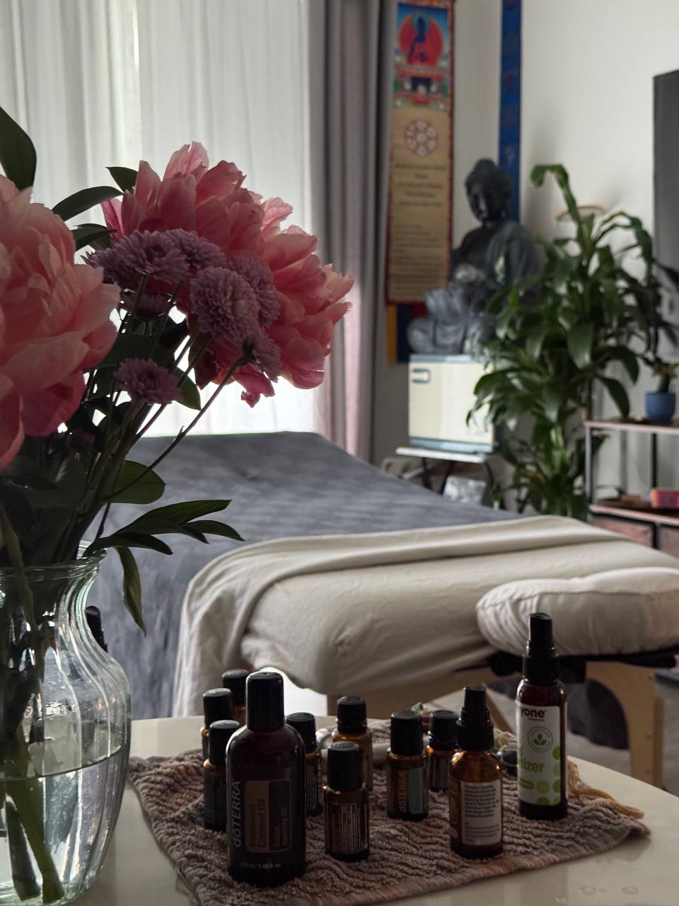 Daroma Wellness — The set-up — table, linens, oils and flowers ready in a client’s room